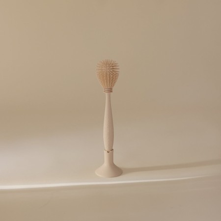 Mushie® Silikonska krtačka za čiščenje Shifting Sand